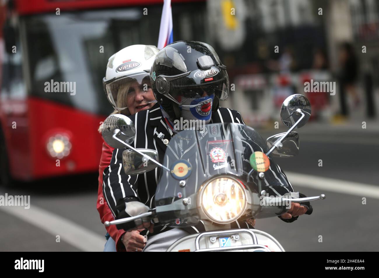 Frank Becket and Karen Miller from Fulham on their scooter at the Cenotaph, in Whitehall, London, to mark the 75th anniversary of VE Day. Picture date: Friday May 8, 2020.  Stock Photo