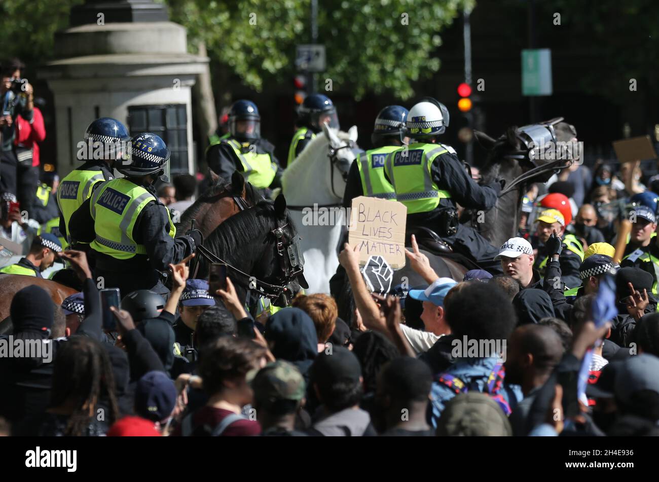 Riot police officers on horses surrounded by demonstrators from Black ...