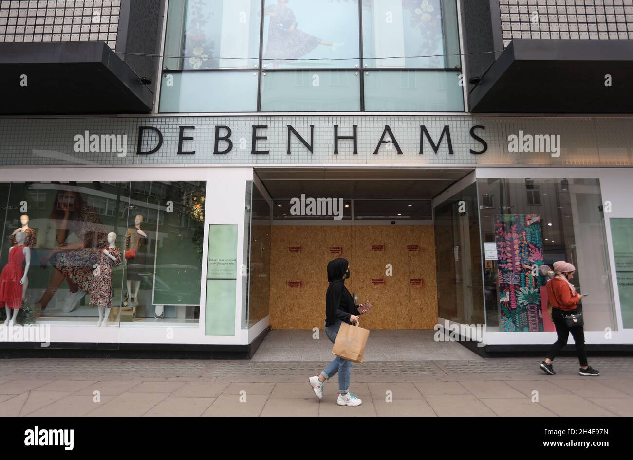 Shoppers walk past a closed Debenhams store on Oxford Street, London, as non-essential shops in England open their doors to customers for the first time since coronavirus lockdown restrictions were imposed in March. Picture date: Monday June 15, 2020. Stock Photo