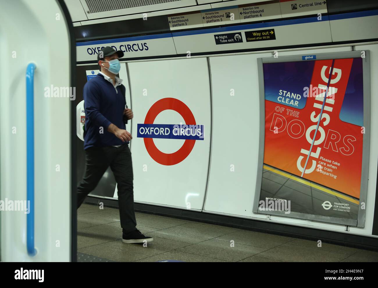 A commuter wearing a protective face mask while traveling through