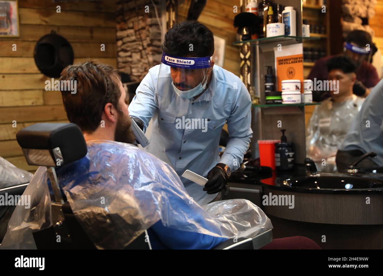 ,Barbers wearing Personal Protective Equipment (PPE) at work at a