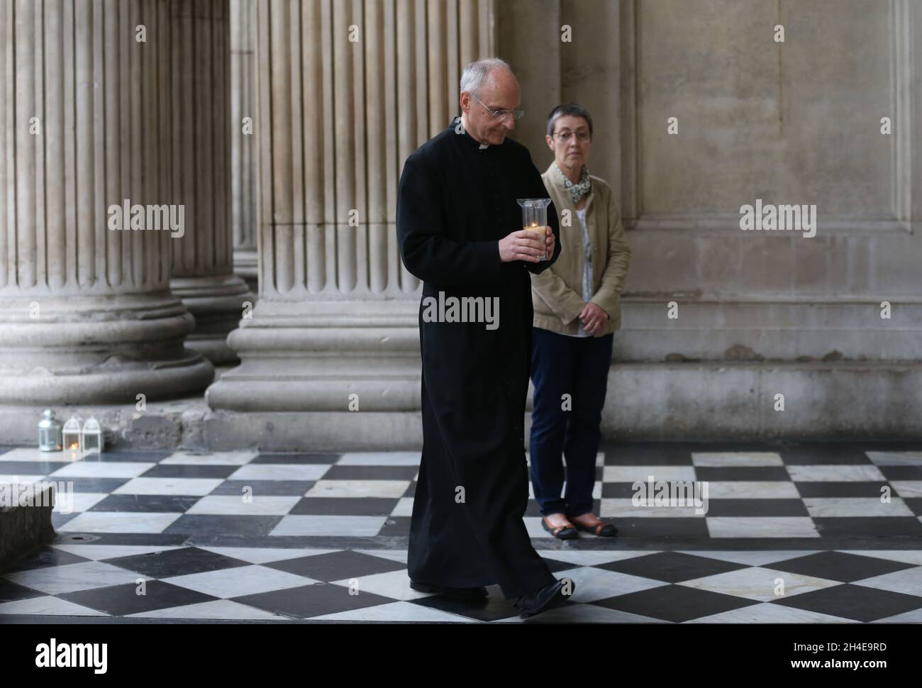 The Dean of St Paulâ€™s, David Ison, brings a candle to the West End portico of the cathedral in London, to remember all those we have lost their lives to Covid-19. Picture date: Saturday July 4, 2020.  Stock Photo