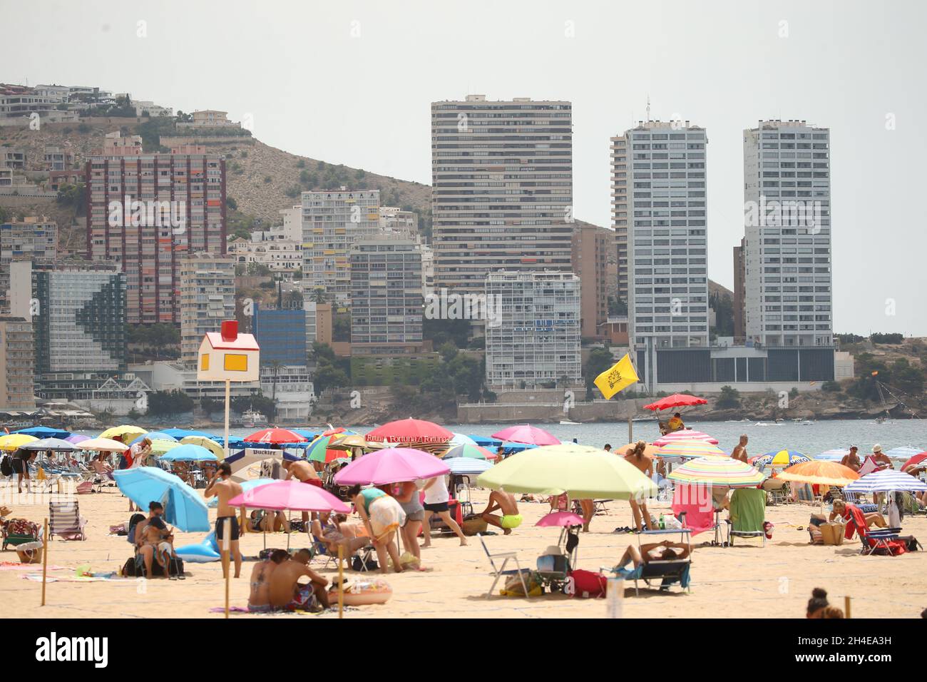 Sunbathers on the Levante beach in Benidorm, a seaside resort on the eastern coast of Spain, which remains almost empty following the UK government’s quarantine to all tourists that travel from Spain because of its high levels of COVID-19 cases. Picture date: Thursday July 30, 2020. Stock Photo