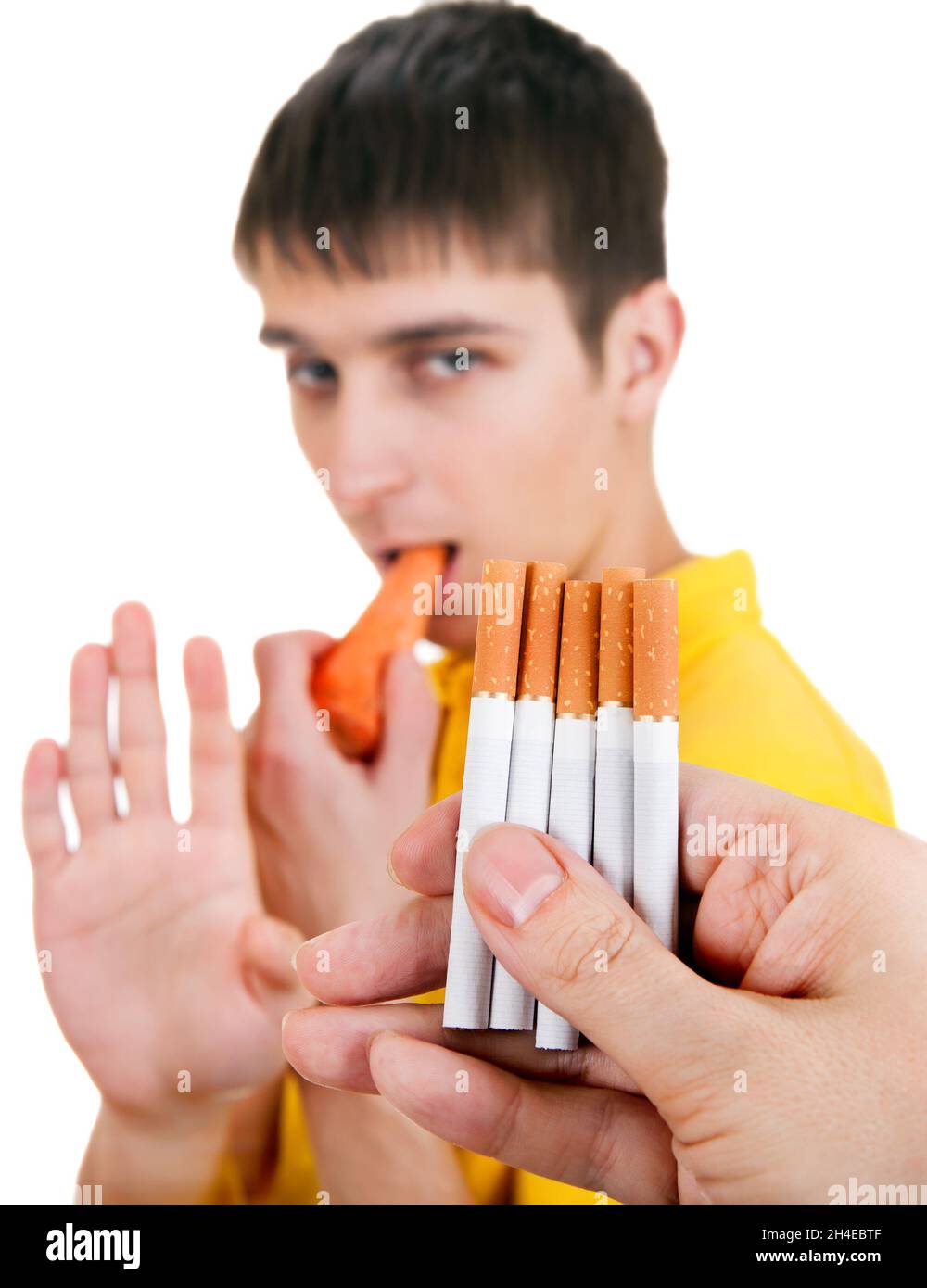 Young Man with Carrot refuse a Cigarettes Isolated on the White Background  Stock Photo