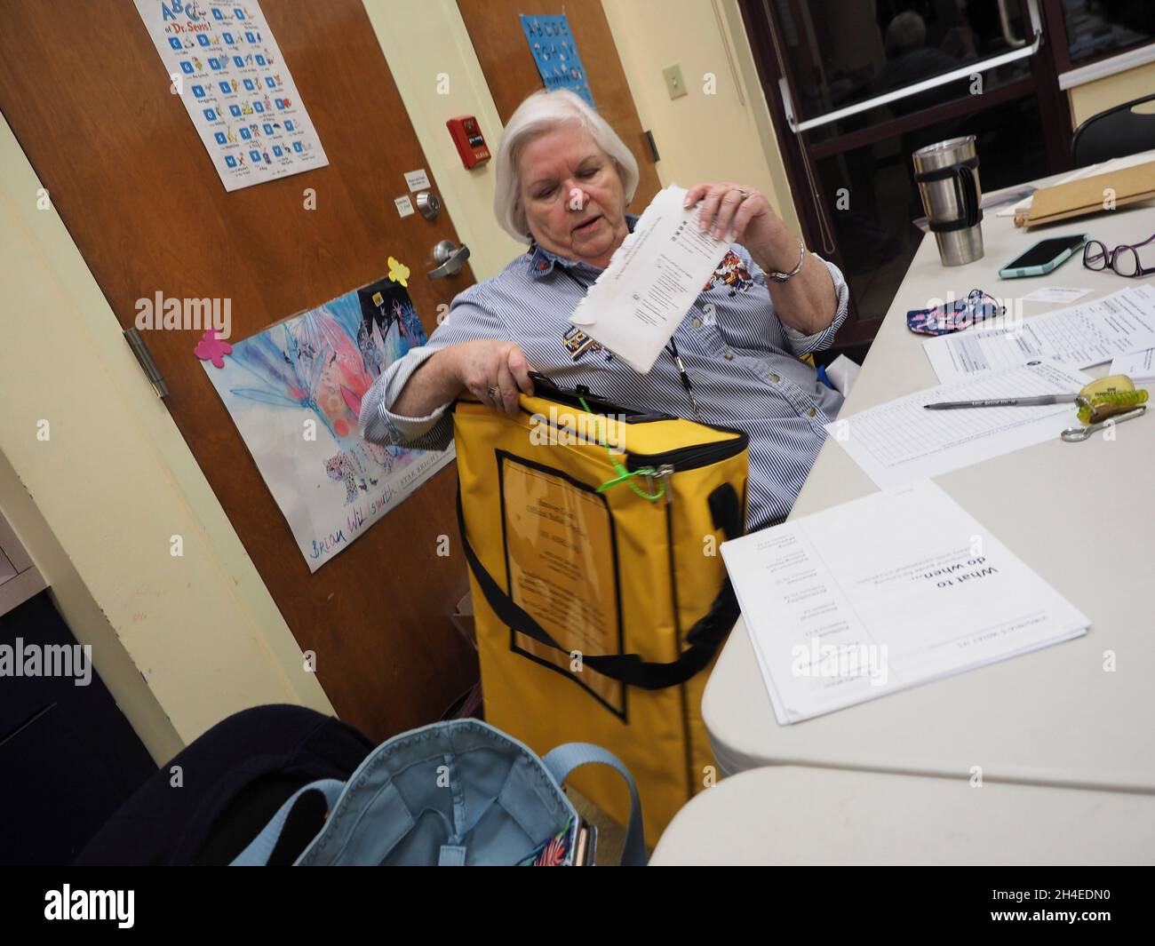 Ashland, Virginia, USA. 2nd Nov, 2021. The Precinct Chief places a spoiled absentee ballot into a secured pouch and then clears the voter to be able to vote in person. Polls opened for voting at 6am for the Virginia elections. (Credit Image: © Sue Dorfman/ZUMA Press Wire) Stock Photo
