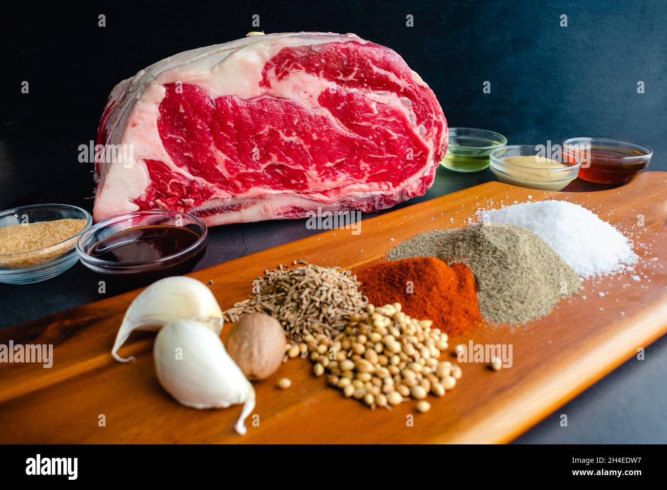 Standing Prime Rib Roast Ingredients: Uncooked beef rib roast with spices and other ingredients Stock Photo