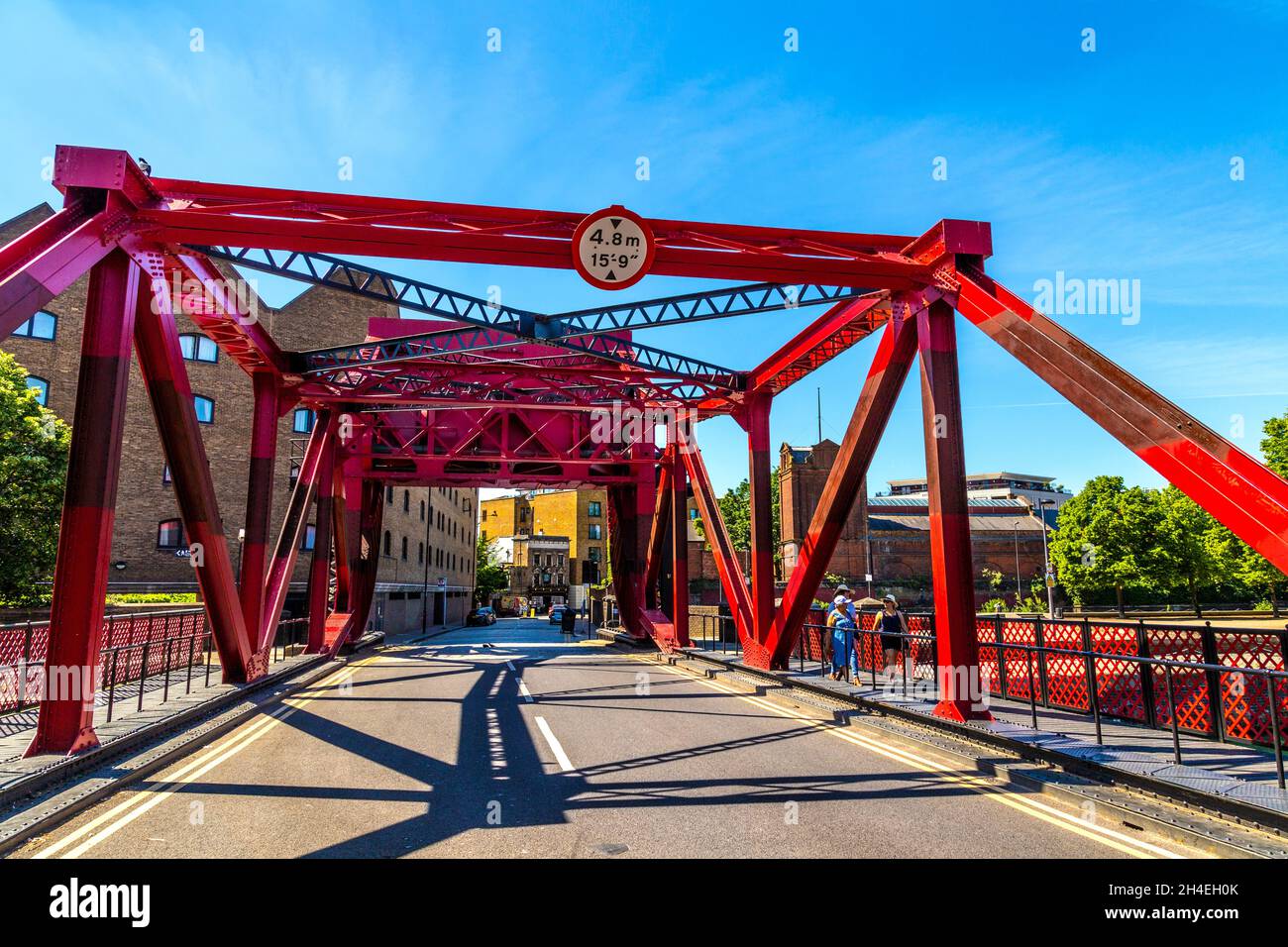 Red steel 1930s bascule bridge over Shadwell Basin, Wapping, London, UK Stock Photo