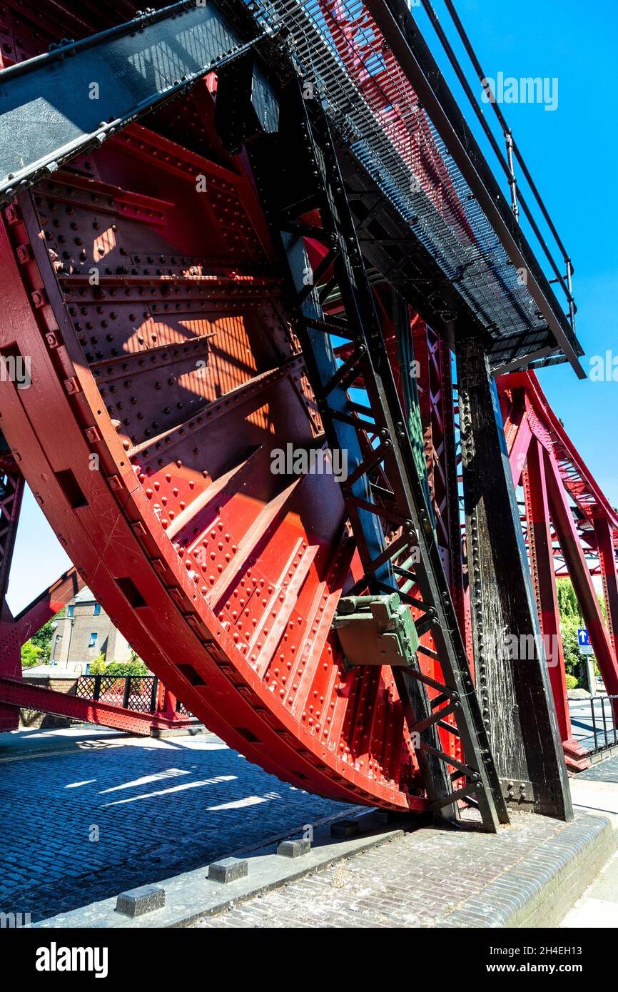 Red steel 1930s bascule bridge over Shadwell Basin, Wapping, London, UK Stock Photo