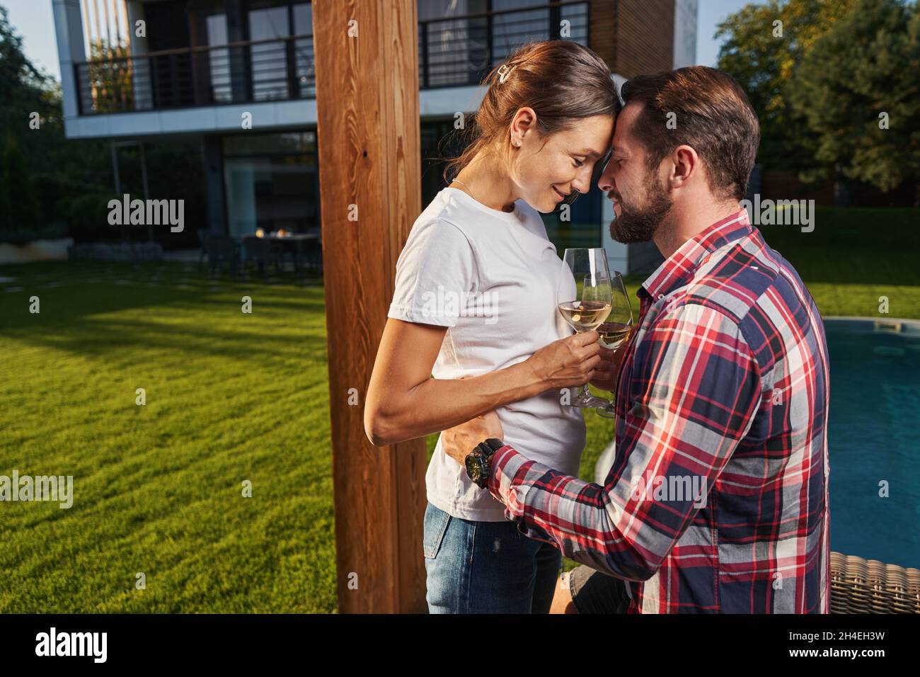 Handsome man hugging his girlfriend while resting in the outdoors Stock Photo