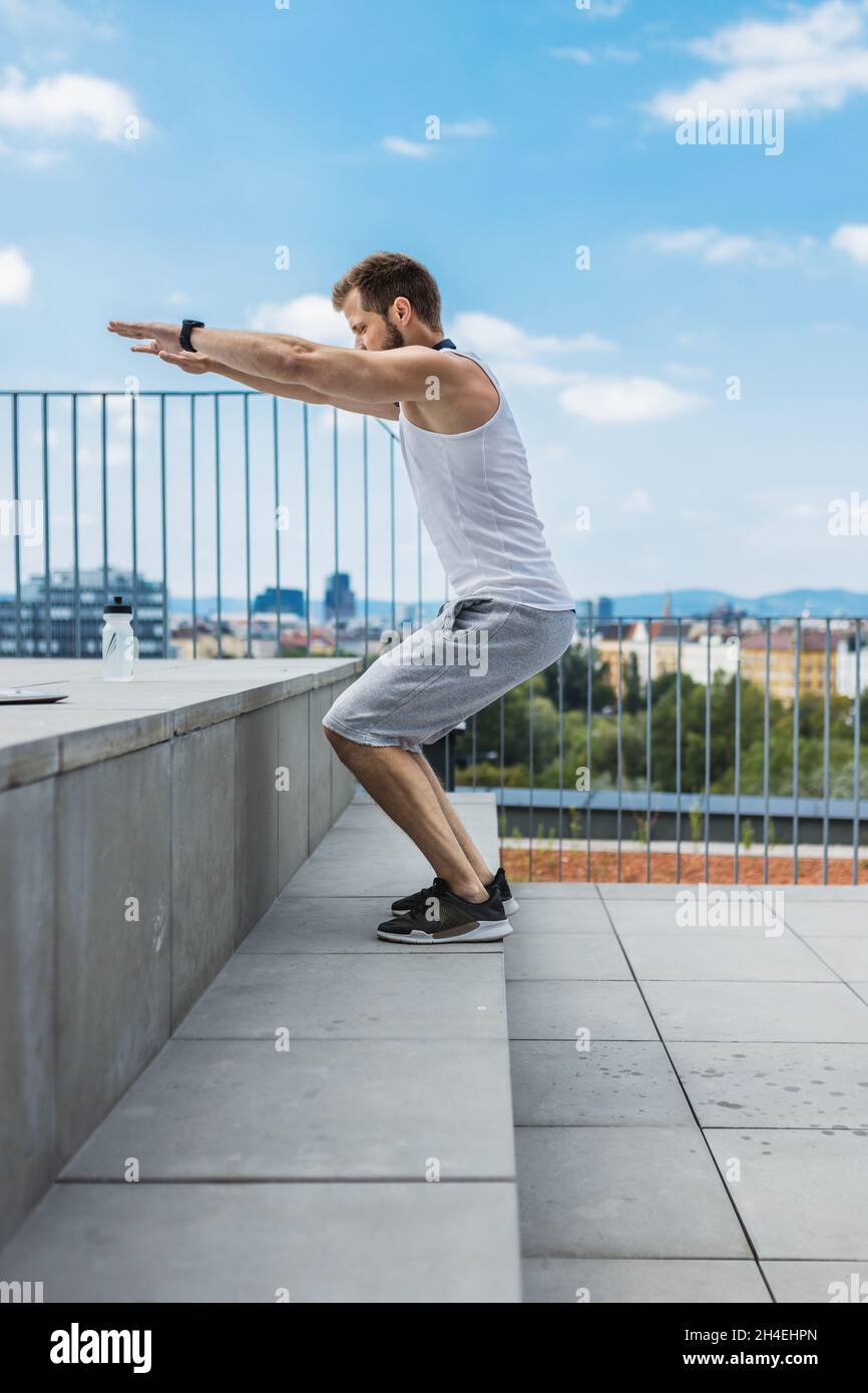 Handsome young man training and working out outdoors Stock Photo