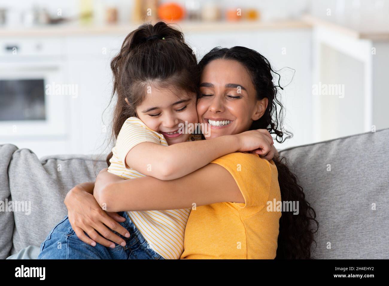 Loving Family. Happy Arab Mom And Little Daughter Cuddling At Home