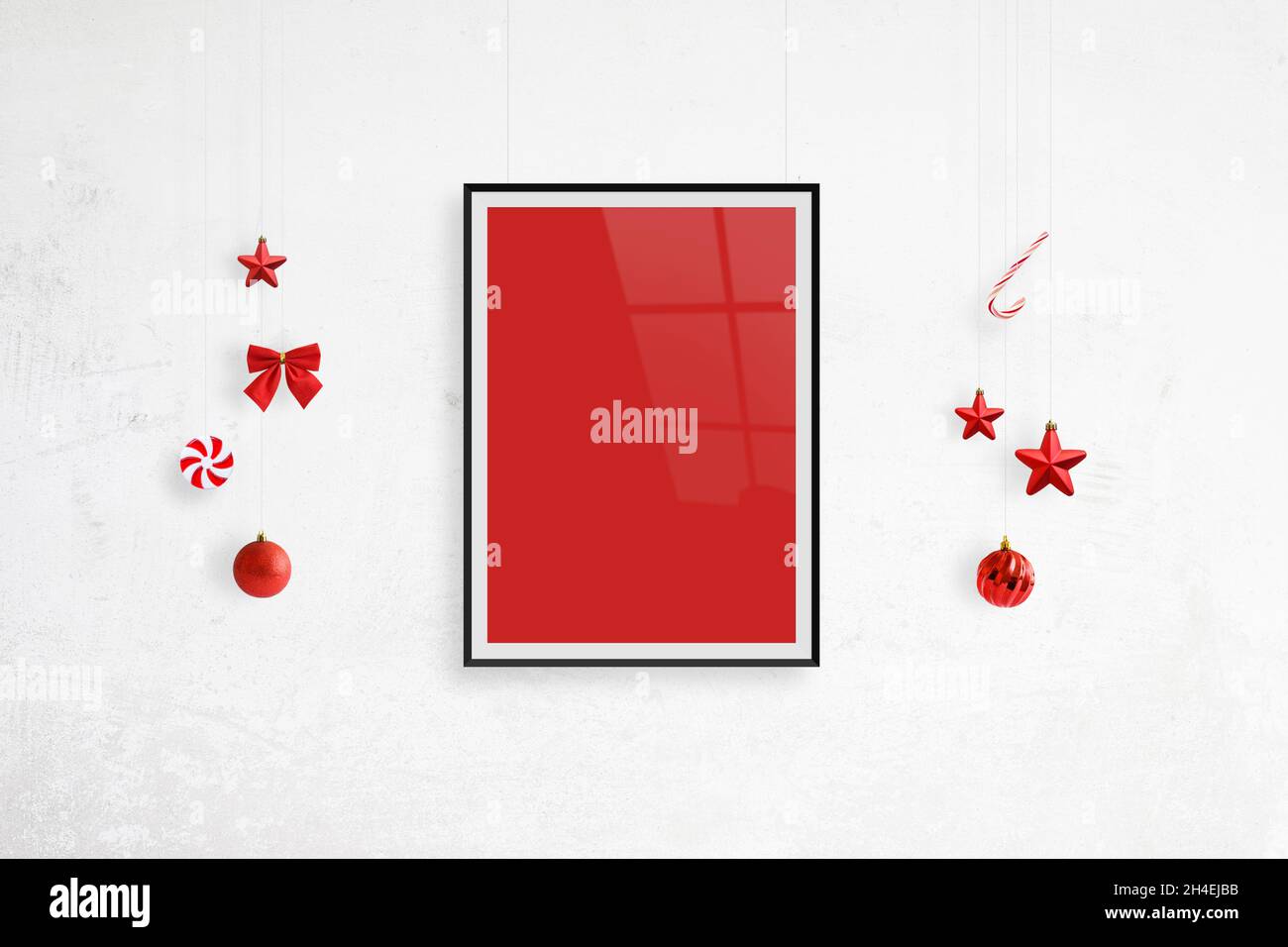 Hanging poster frame mockup surrounded by Christmas decorations. Blank poster frame for greeting text Stock Photo