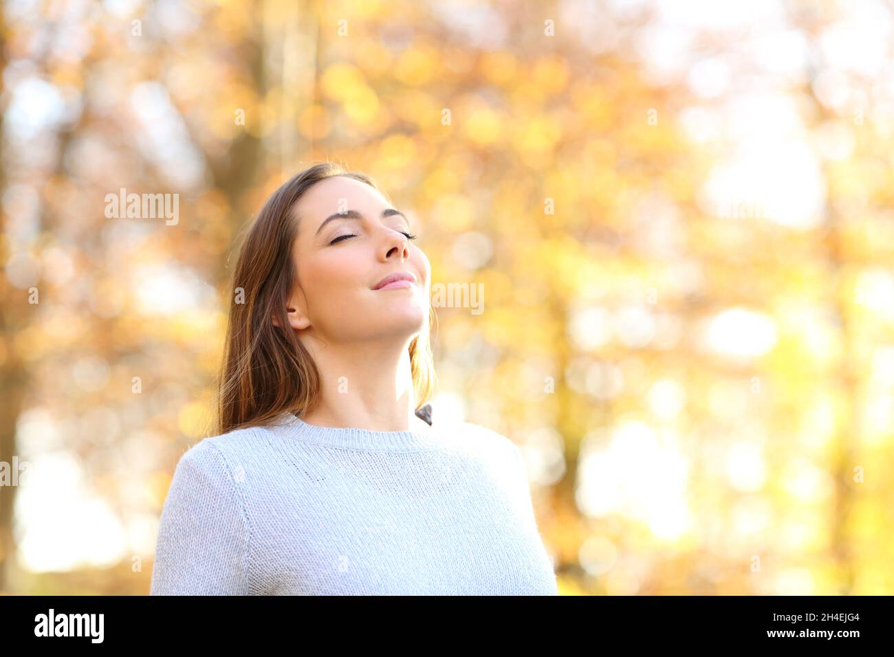 Happy relaxed female breathing fresh air in autumn in a forest Stock ...