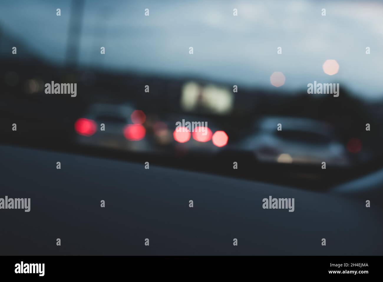 Cars and car lights in evening traffic from inside the car with