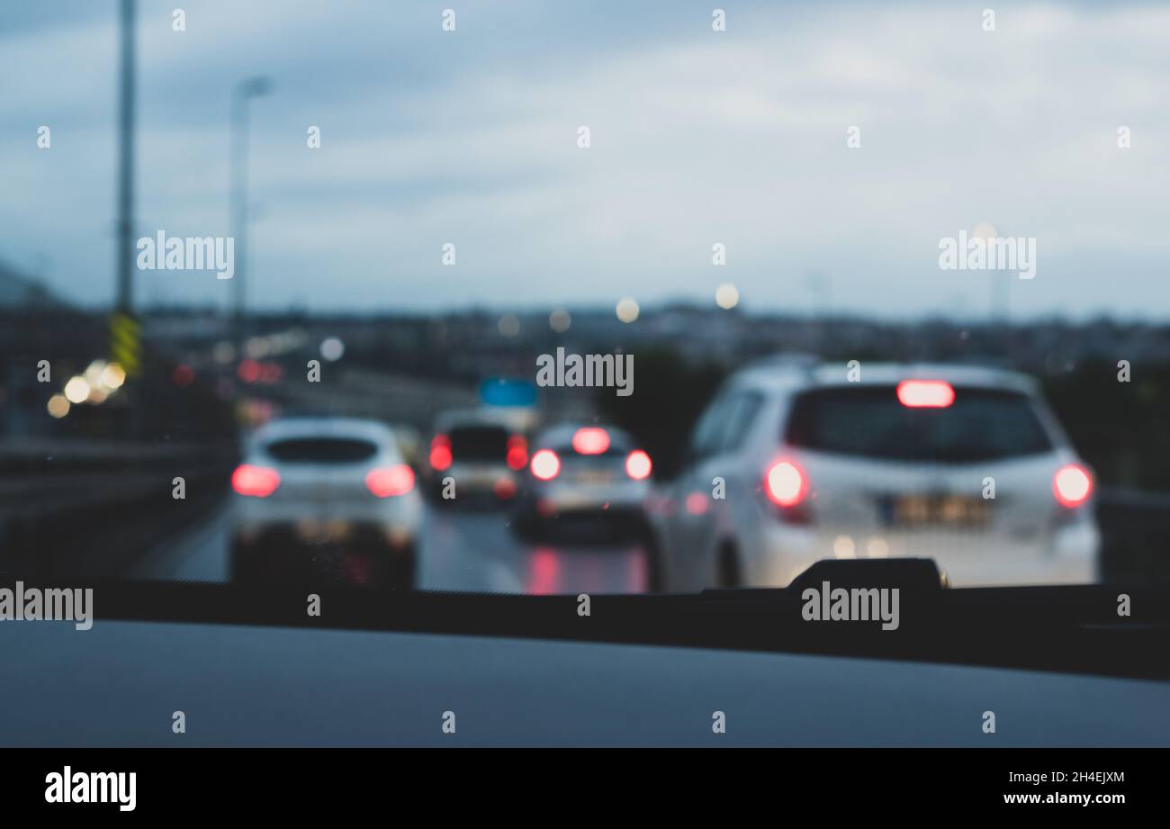 Cars and car lights in evening traffic from inside the car with