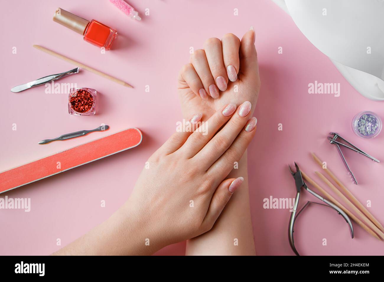 Nail care procedure in a beauty salon. Female hands and tools for
