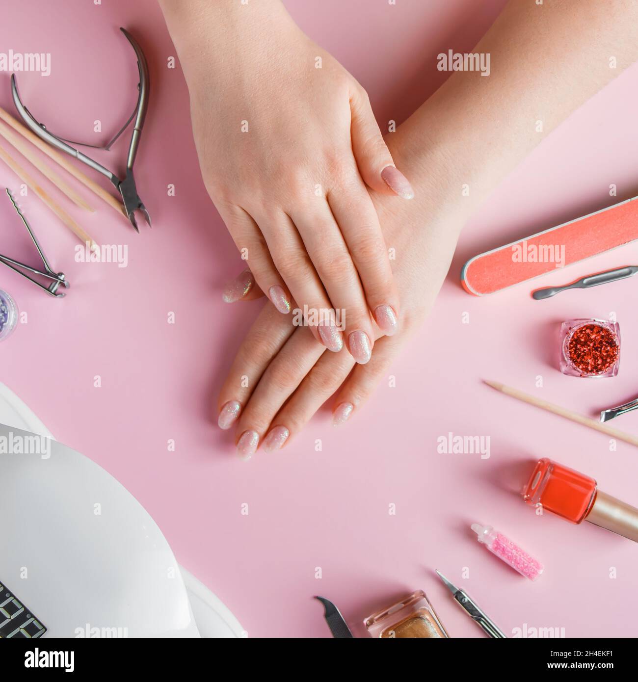 Nail care procedure in a beauty salon. Female hands and tools for
