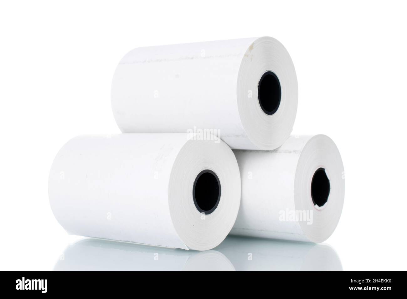 Three rolls of paper cash register tape, closeup isolated on white