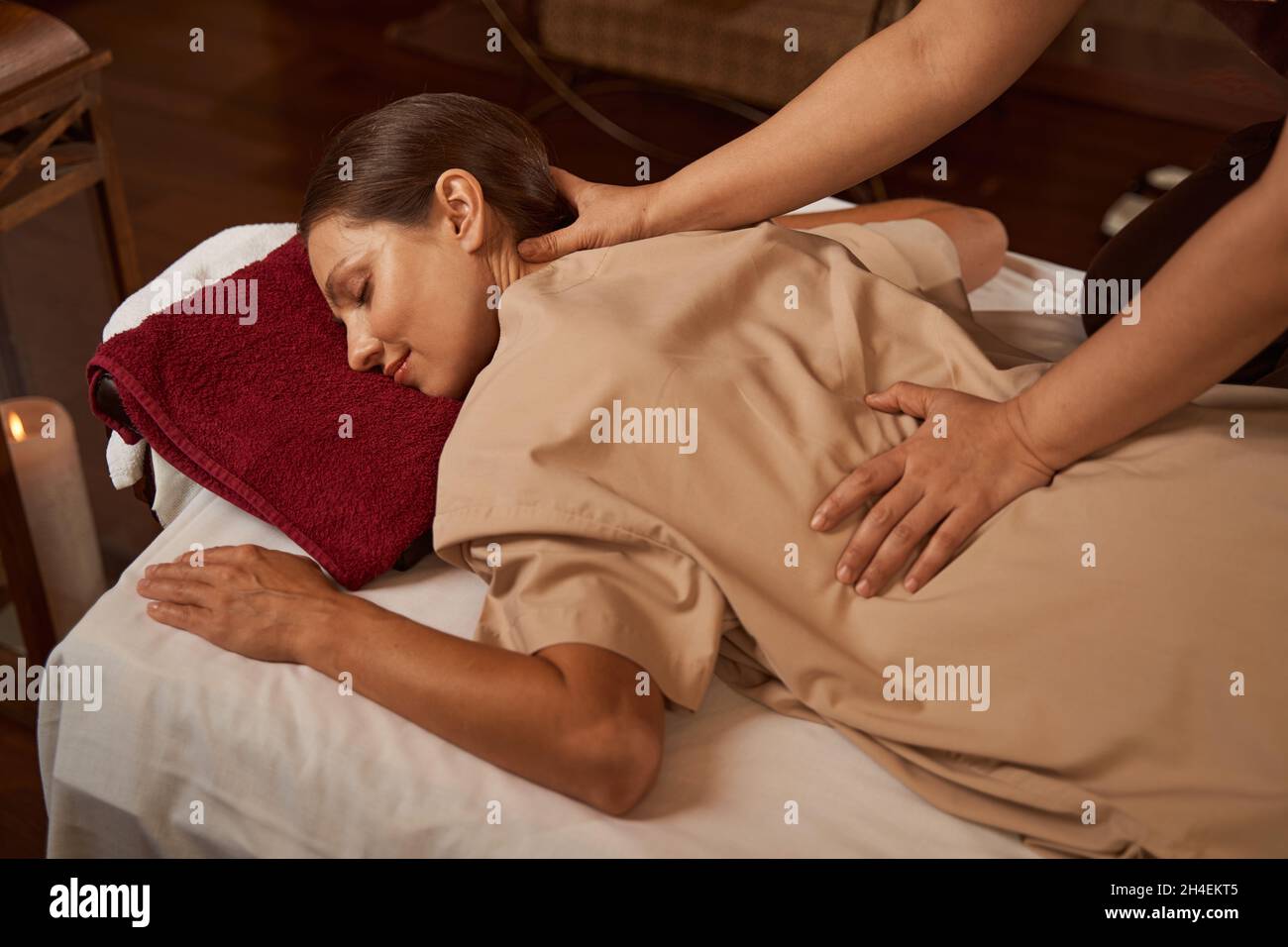 Massotherapist hands pressing on patient trigger points Stock Photo