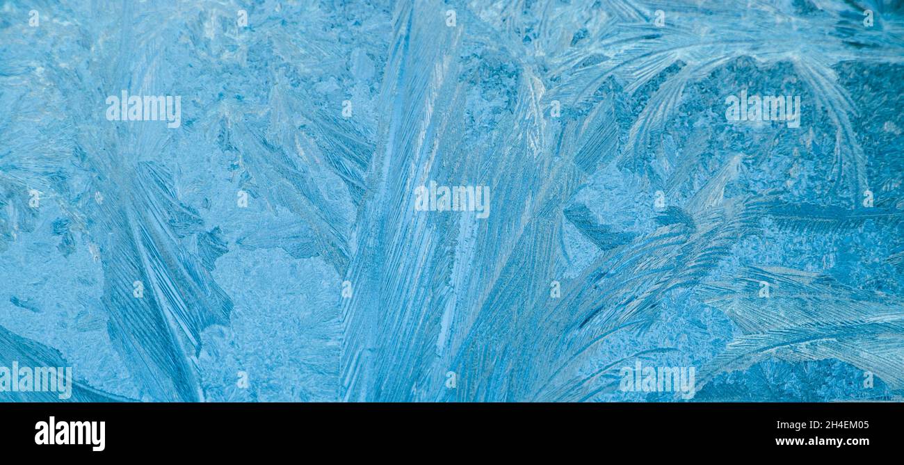 Frosty patterns on glass. Christmas background. Ice on winter window ...