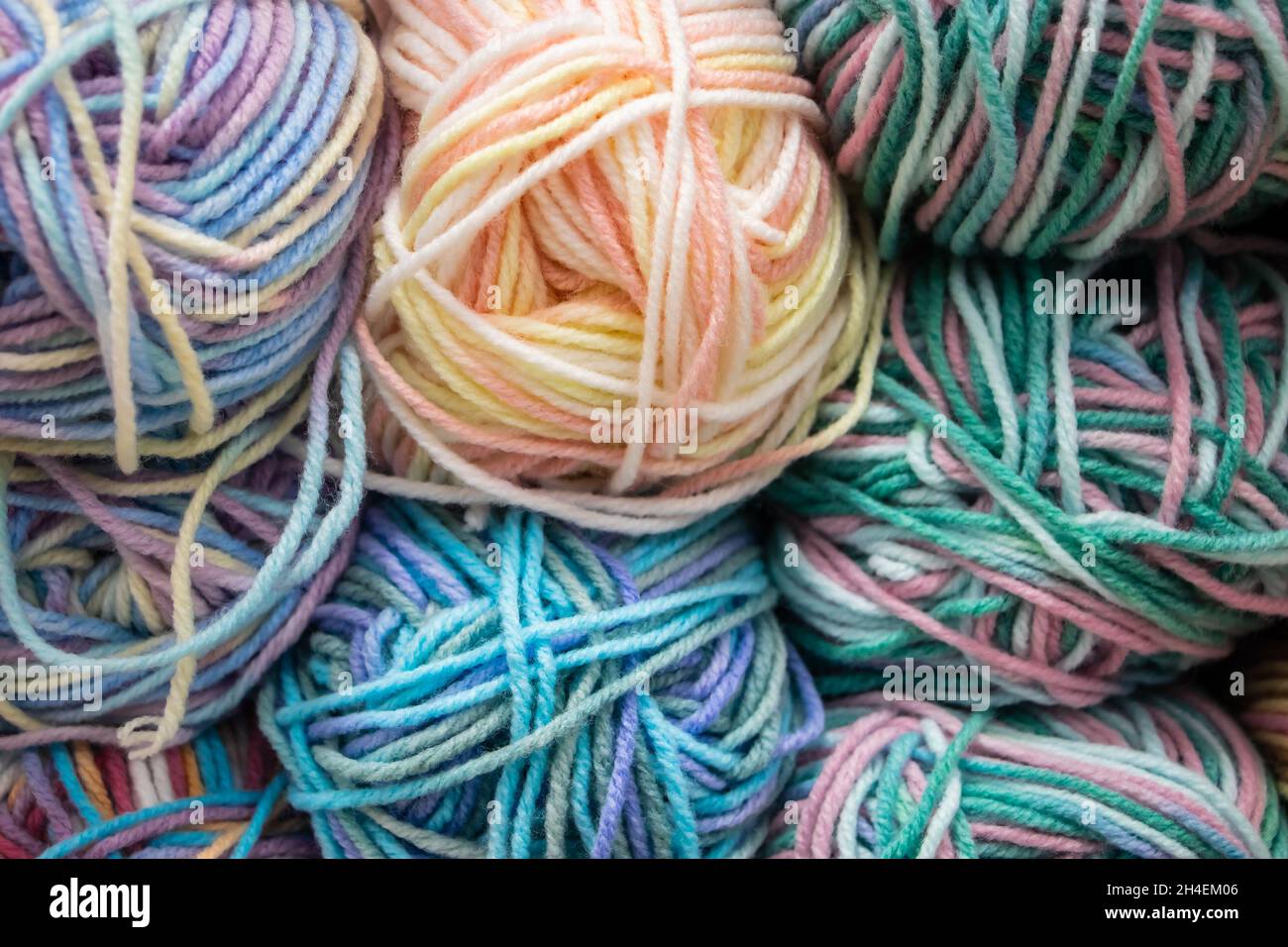 Many balls of wool yarn for knitting. Selling fluffy threads in a craft store. Stock Photo