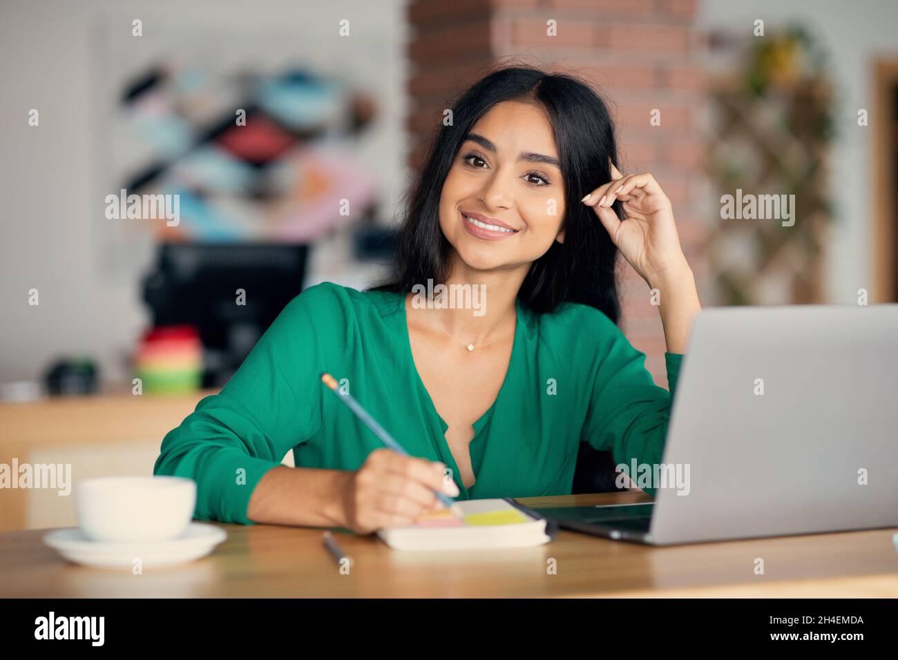 Beautiful indian woman freelancer working at cafe Stock Photo
