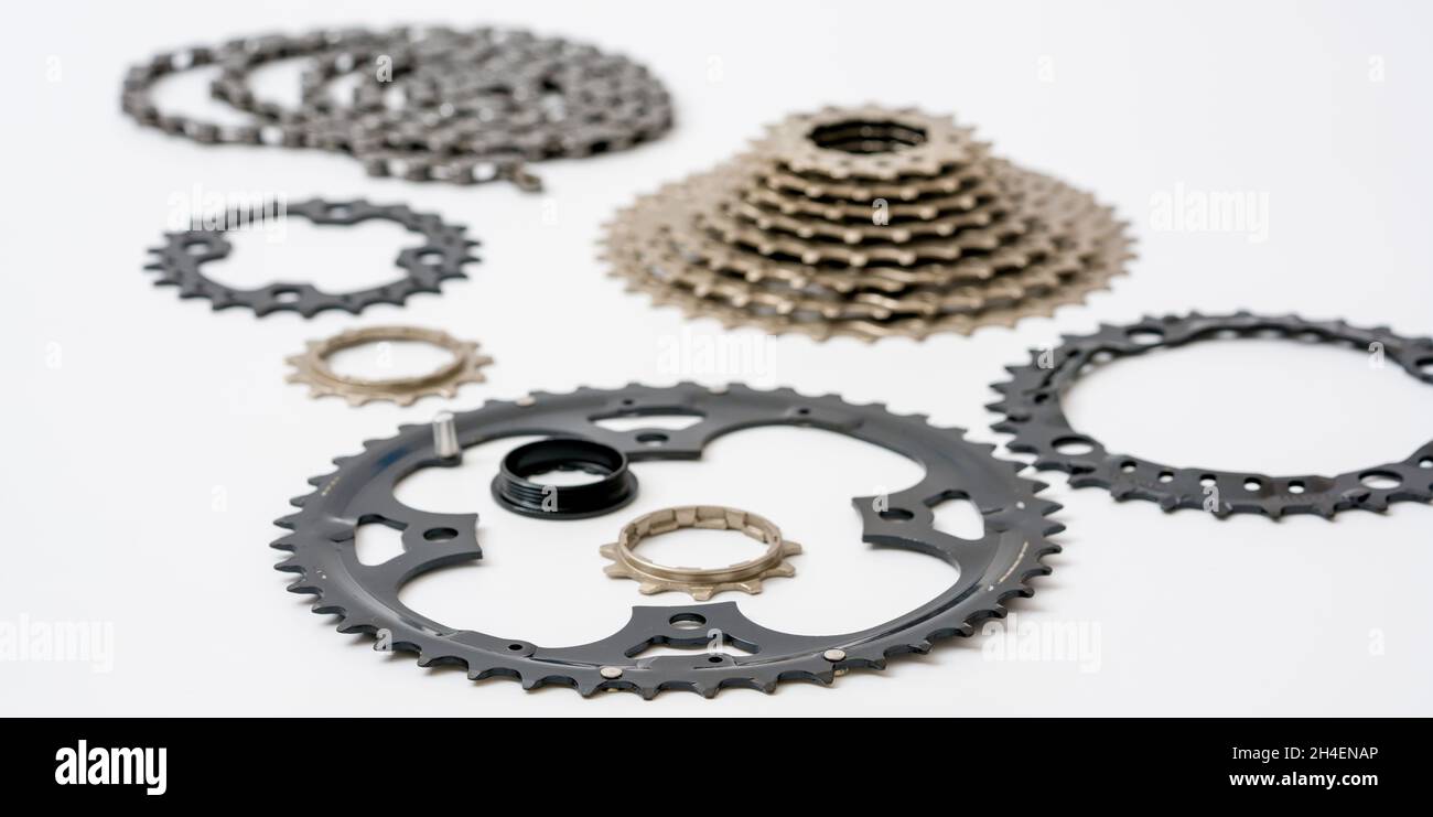 Gears, sprockets and chain of a mountain sports bike on a white
