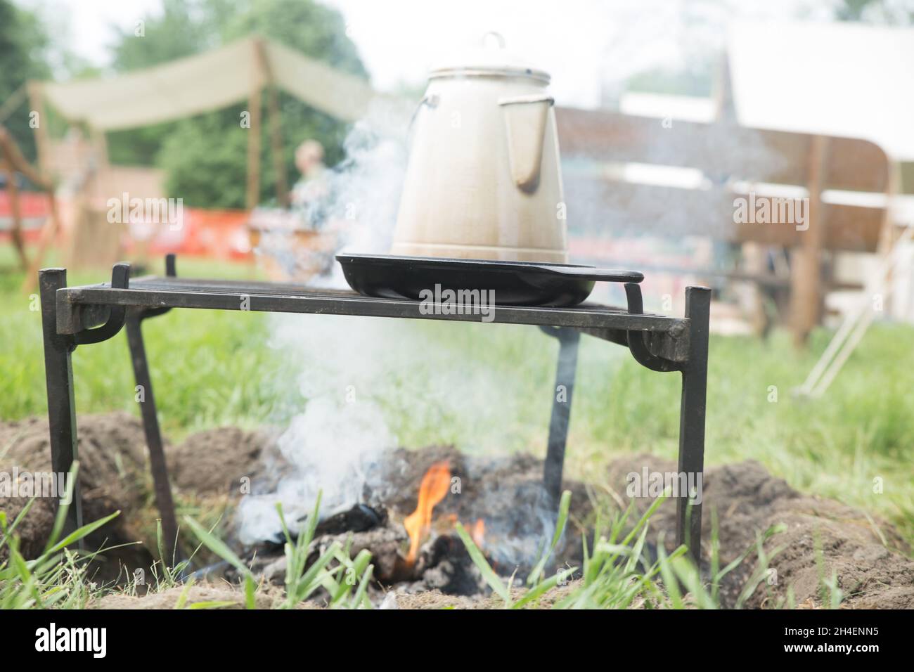 Campfire in the camp with a boiling kettle on it Stock Photo - Alamy