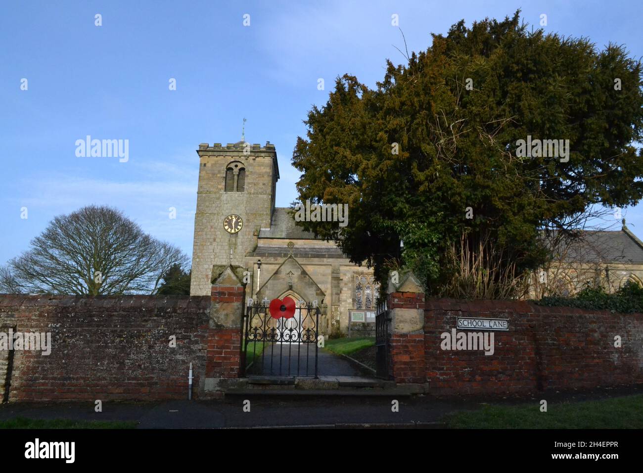 Rudston Church - Gate Way And Path To The Church Door - Church Tower - Blue Sky Stock Photo