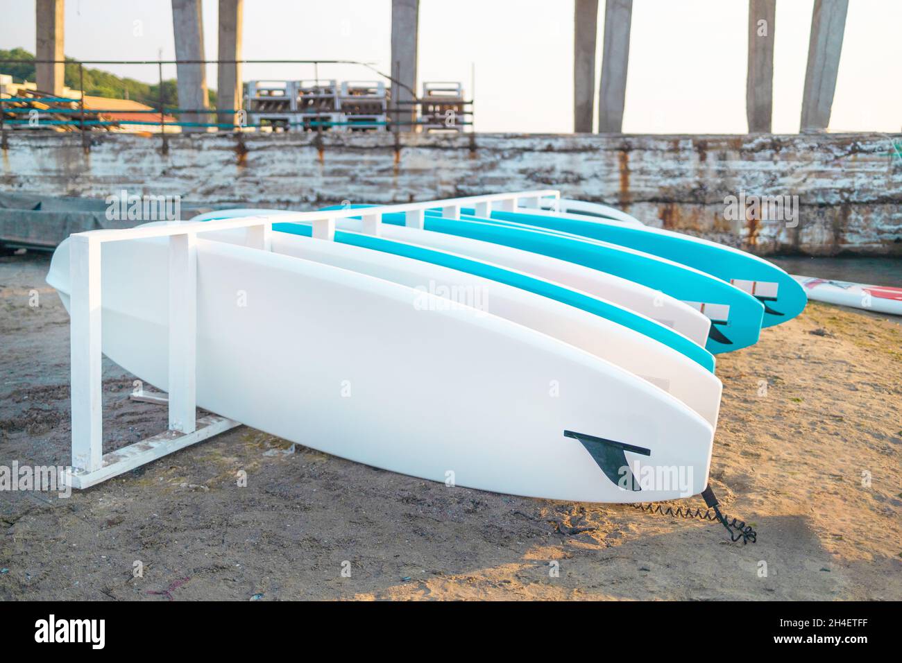 Plactic blue stand up paddle board SUP on the sand for tourist rent ...