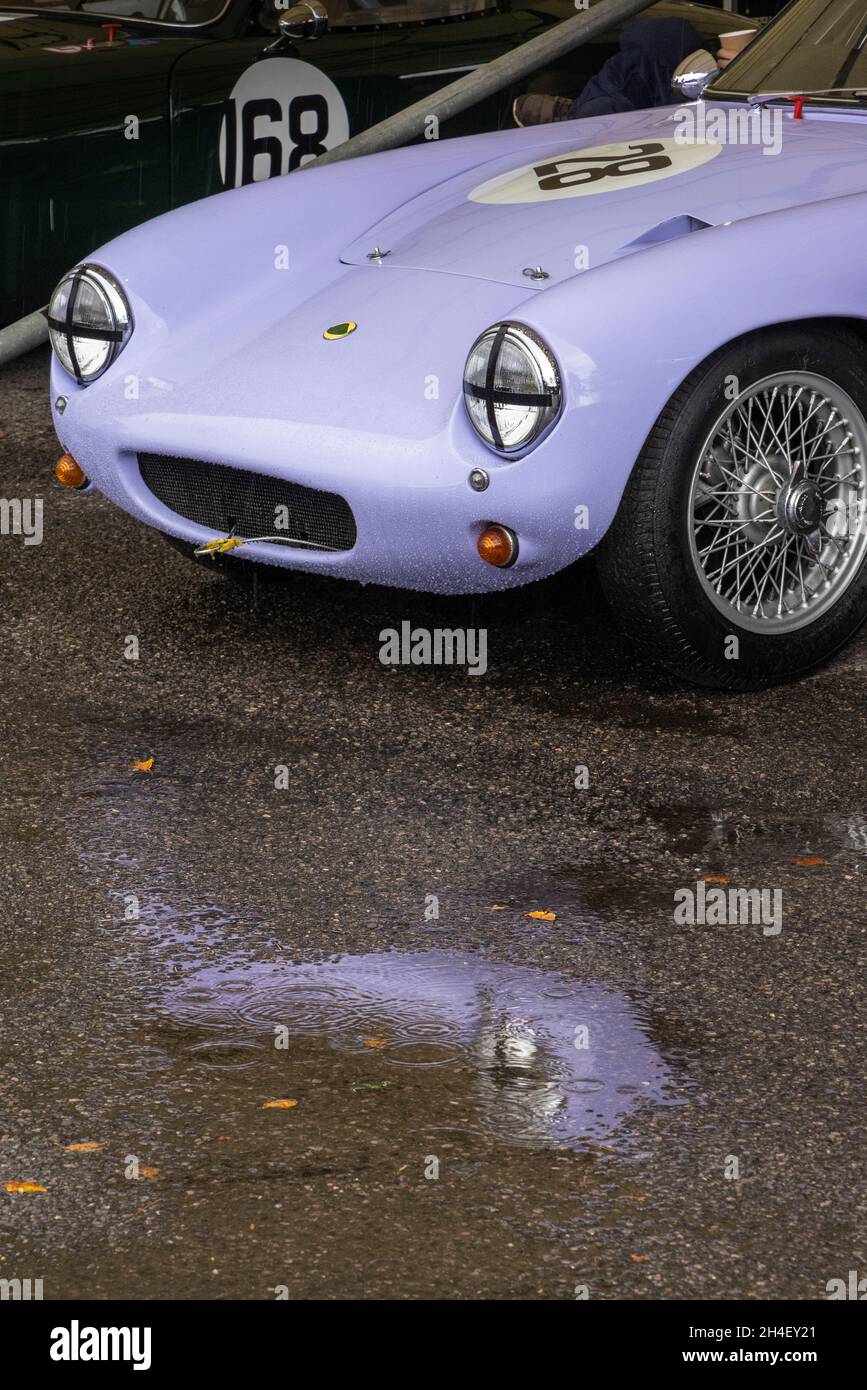 1959 Lotus Elite of Michael Gans in a wet paddock garage with reflection in puddle. Goodwood 78th Members Meeting, Sussex, UK. Stock Photo