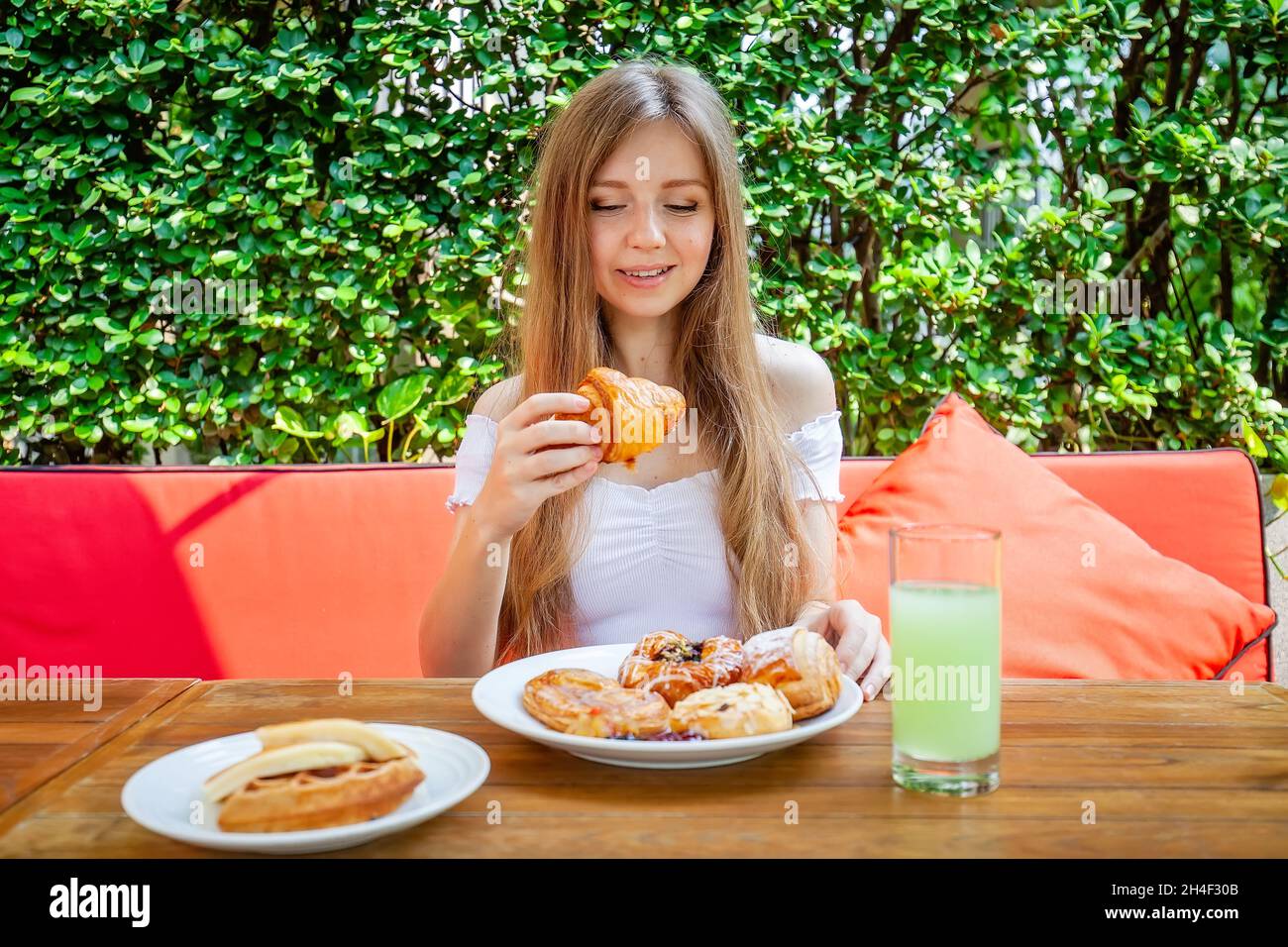 Slim Young Woman on Dieting Thinking About Eating Sweet Pastry, Bakery Stock Photo