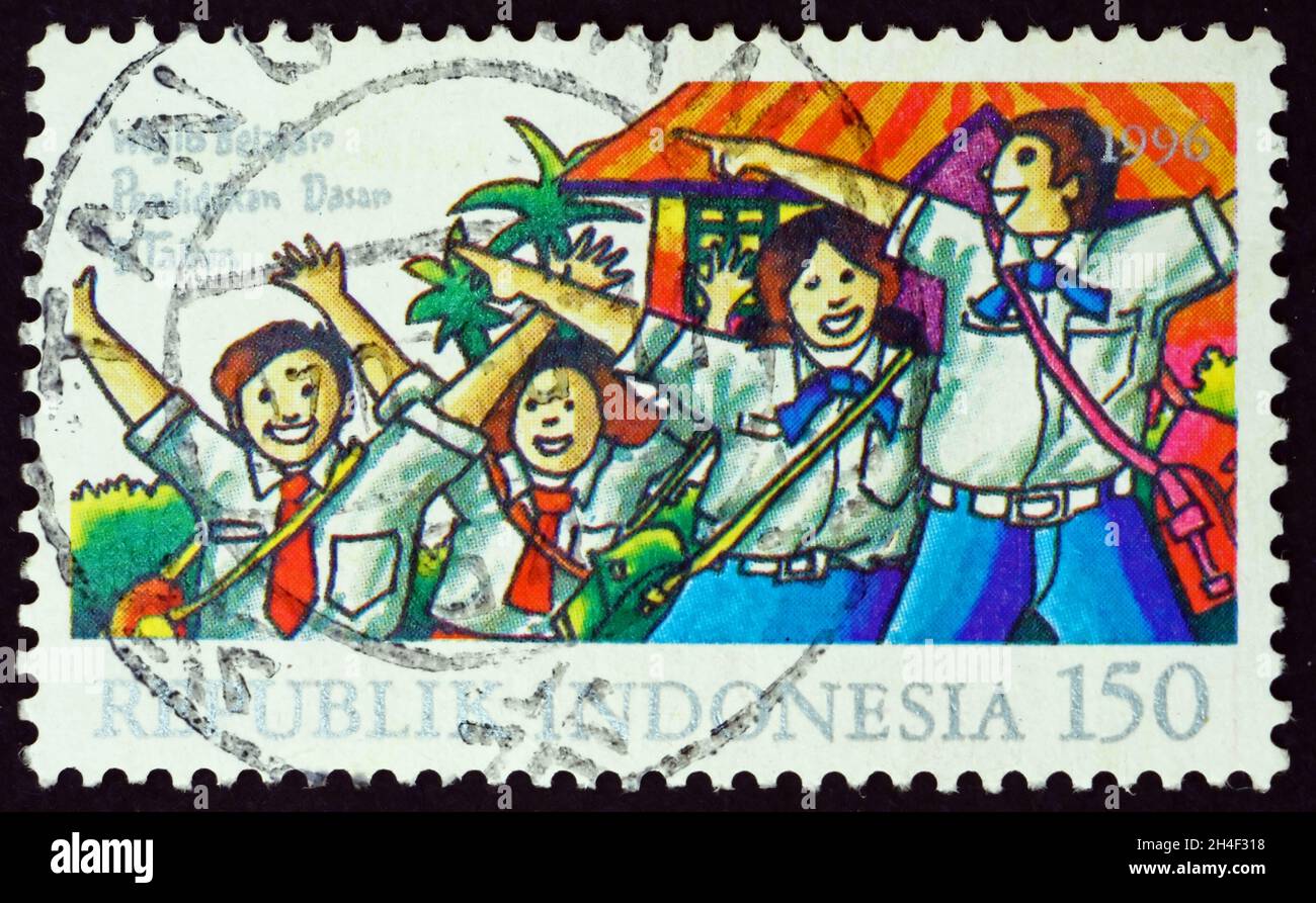 INDONESIA - CIRCA 1996: a stamp printed in Indonesia shows children at playground, foster parents, circa 1996 Stock Photo