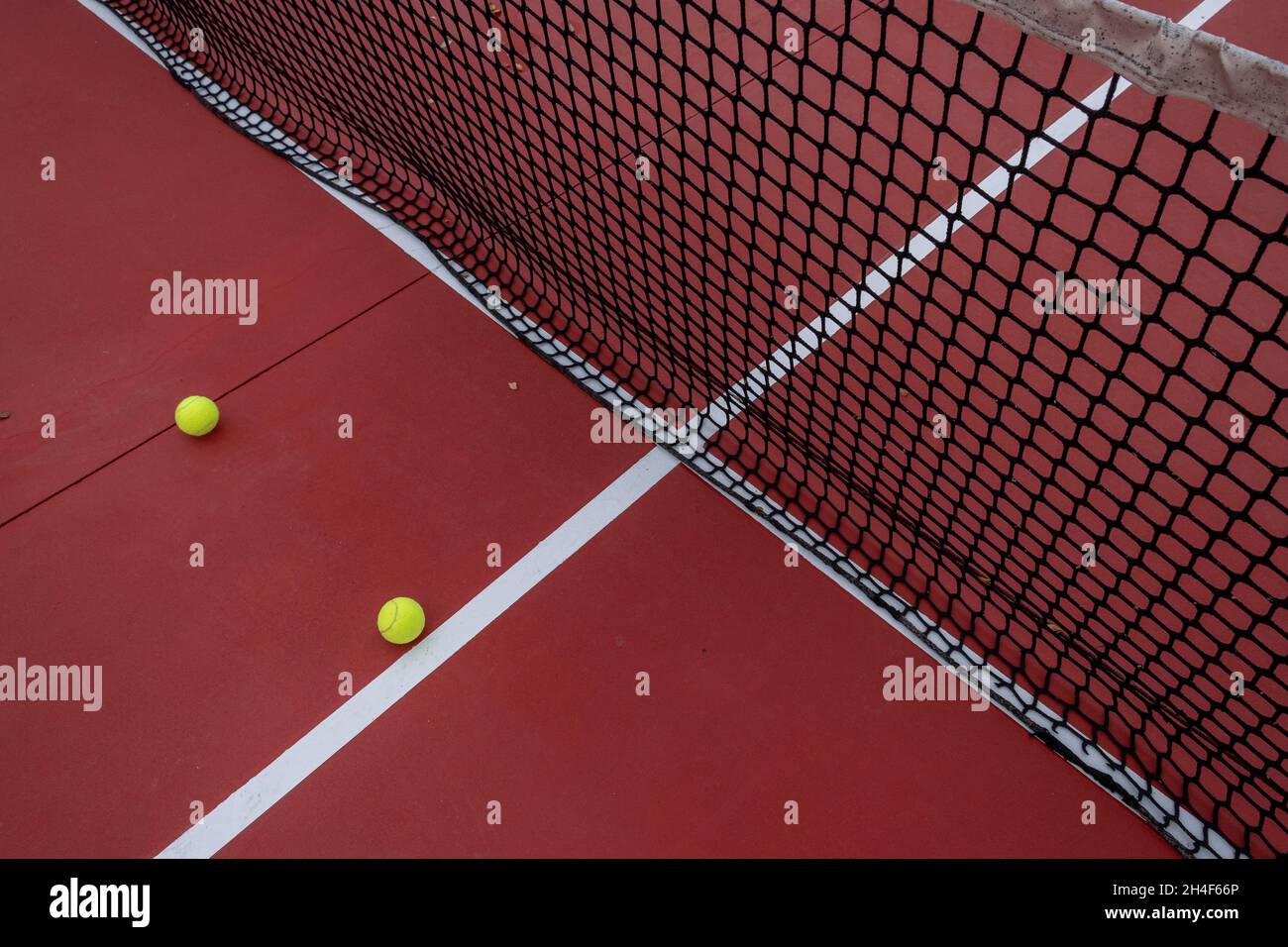 two balls on a red and blue tennis court Stock Photo - Alamy