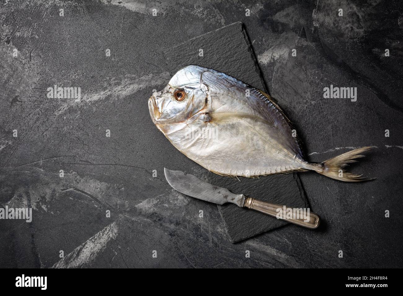 Top view of tasty salty dried sea fish vomer or Selena with silver