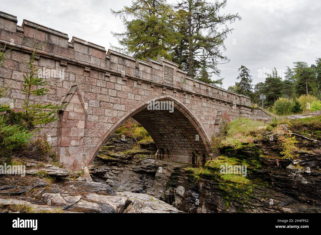 The stone bridge that goes over the rapids of the river Dee in the Cairngorms Mountains of Scotland Stock Photo