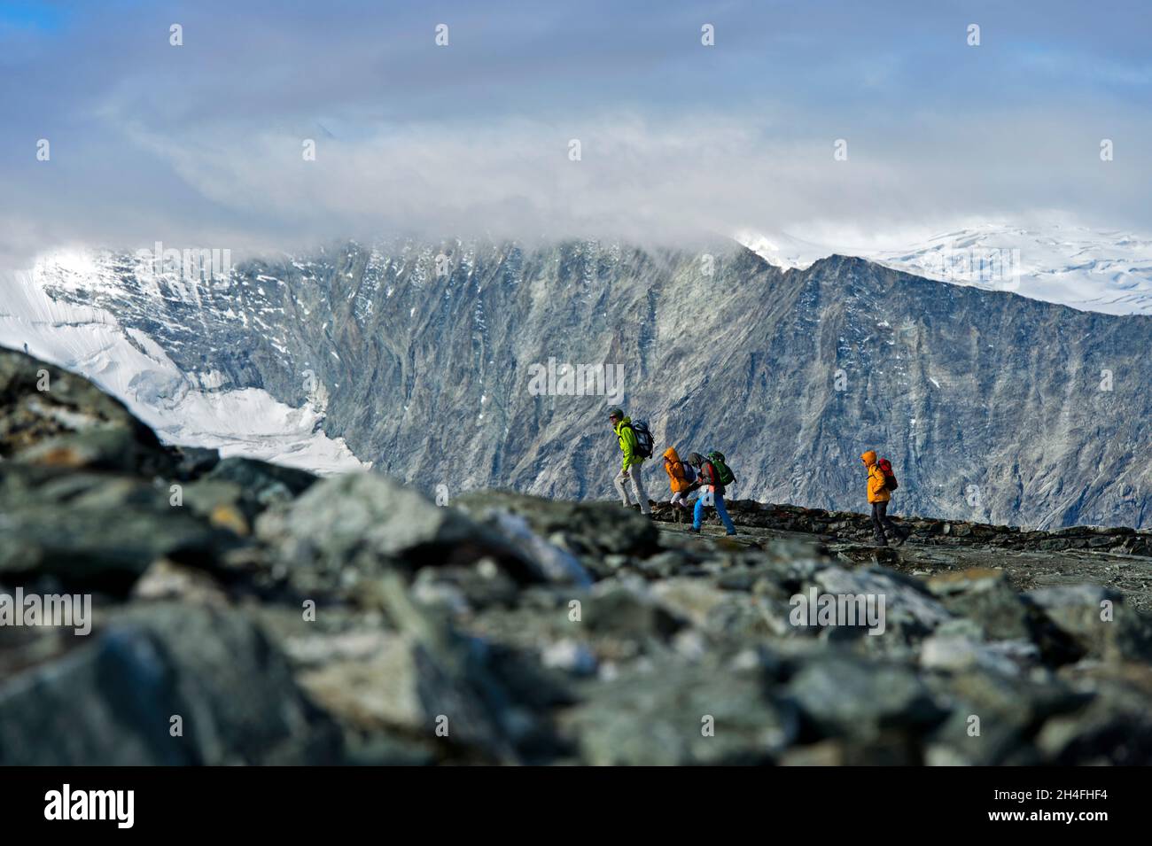 Hikers in the Swiss Alps, near Zinal, Val d’Anniviers,Valais, Switzerland Stock Photo