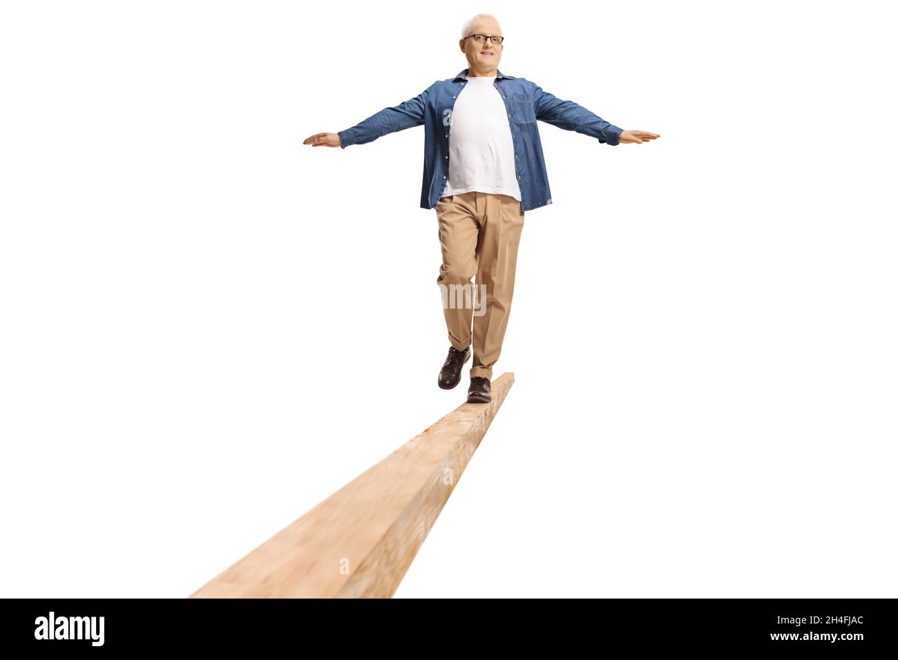 Full length shot of a mature man with white hair walking on beam isolated on white background Stock Photo