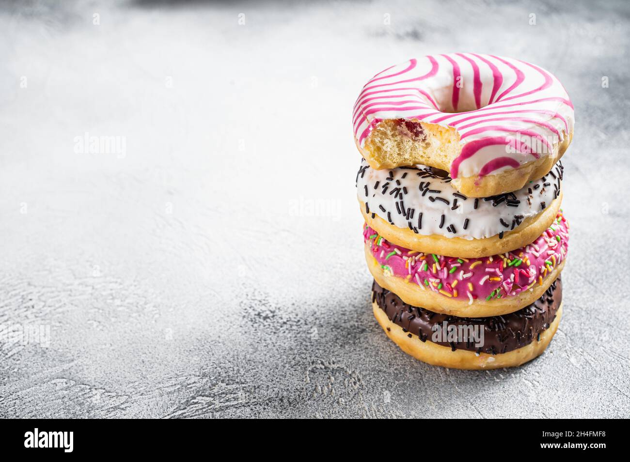 Stack of artisan donuts. White background. Top view. Copy space Stock Photo