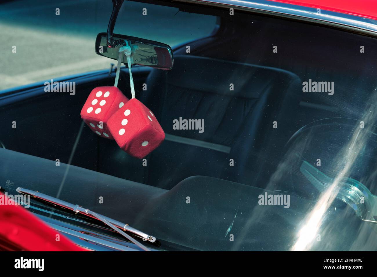 Custom car interior with large dice hanging on mirror is displayed at the 2021 Endless Summer Cruisin in Ocean City Maryland. Stock Photo