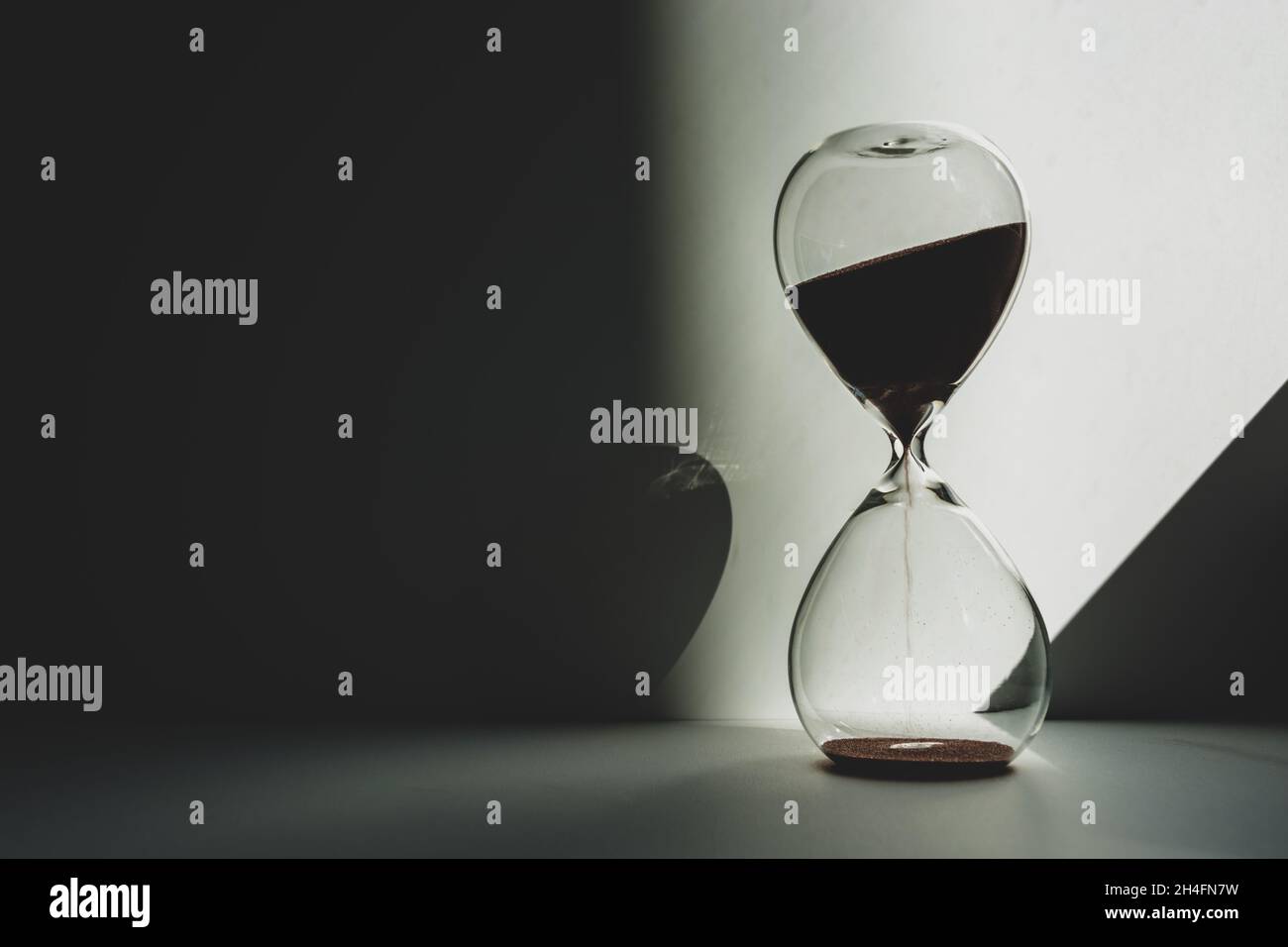 Time is measured by an hourglass in the twilight illuminated by