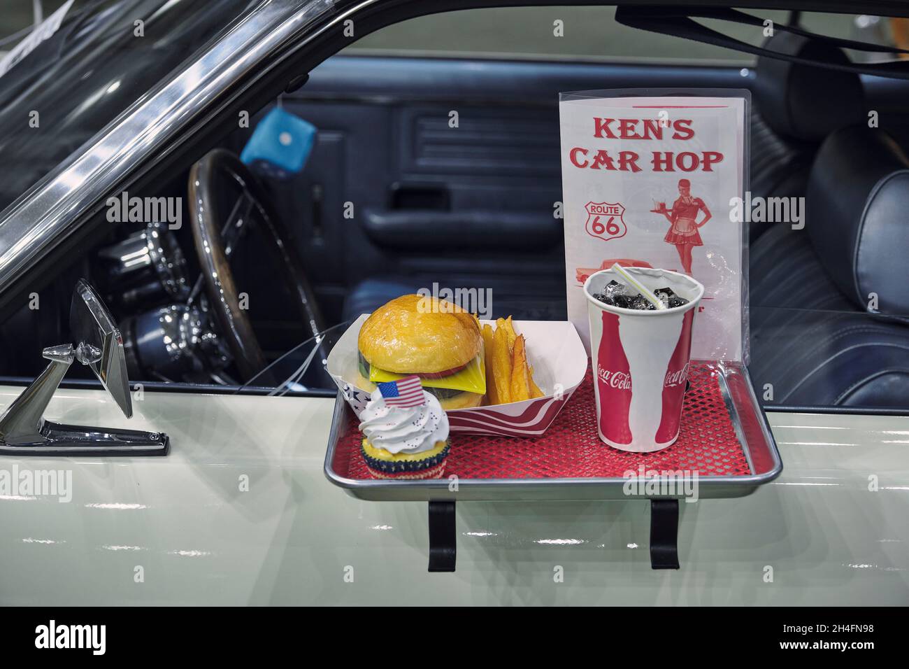 A custom car displays a vintage car hop tray with burger and fries at the 2021 Endless Summer Cruisin in Ocean City Maryland. Stock Photo