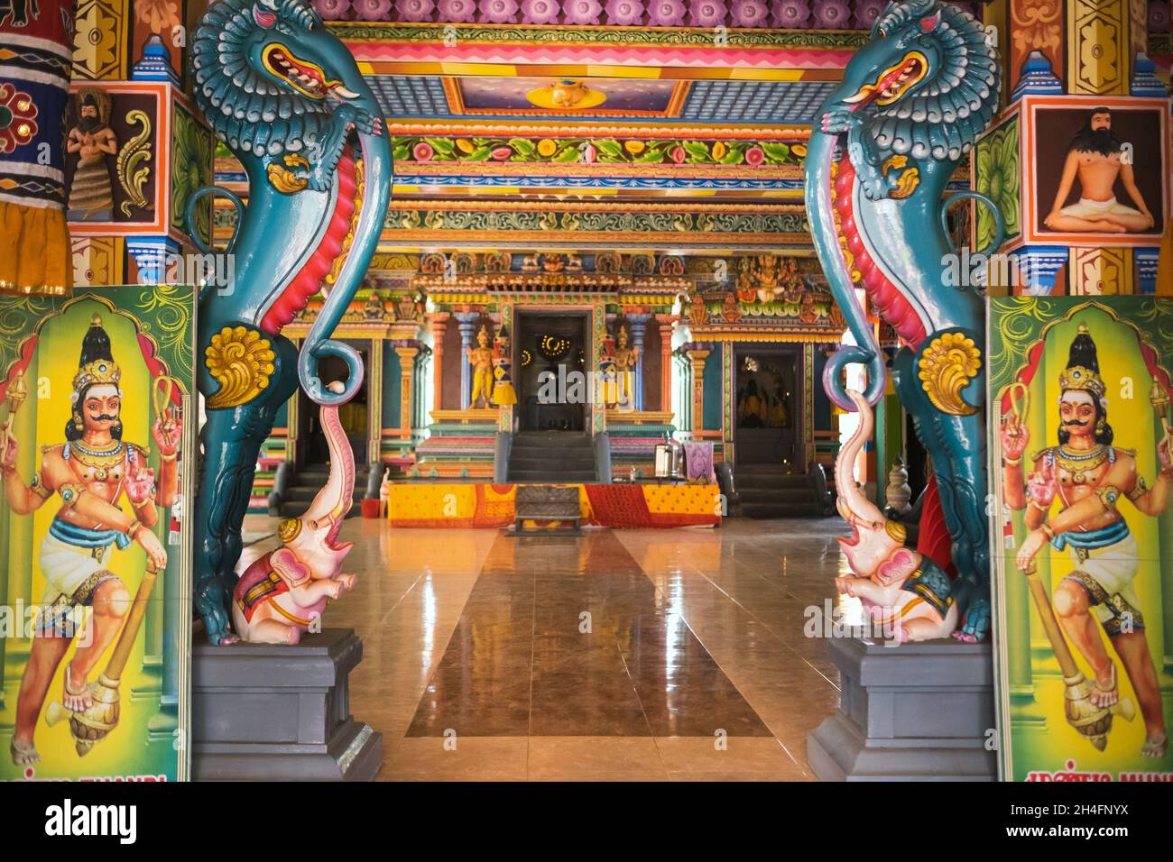 Part of a beautiful and colorful Indian temple in Mauritius Island. Close-up on sculptures and statues of Indian deities. Stock Photo