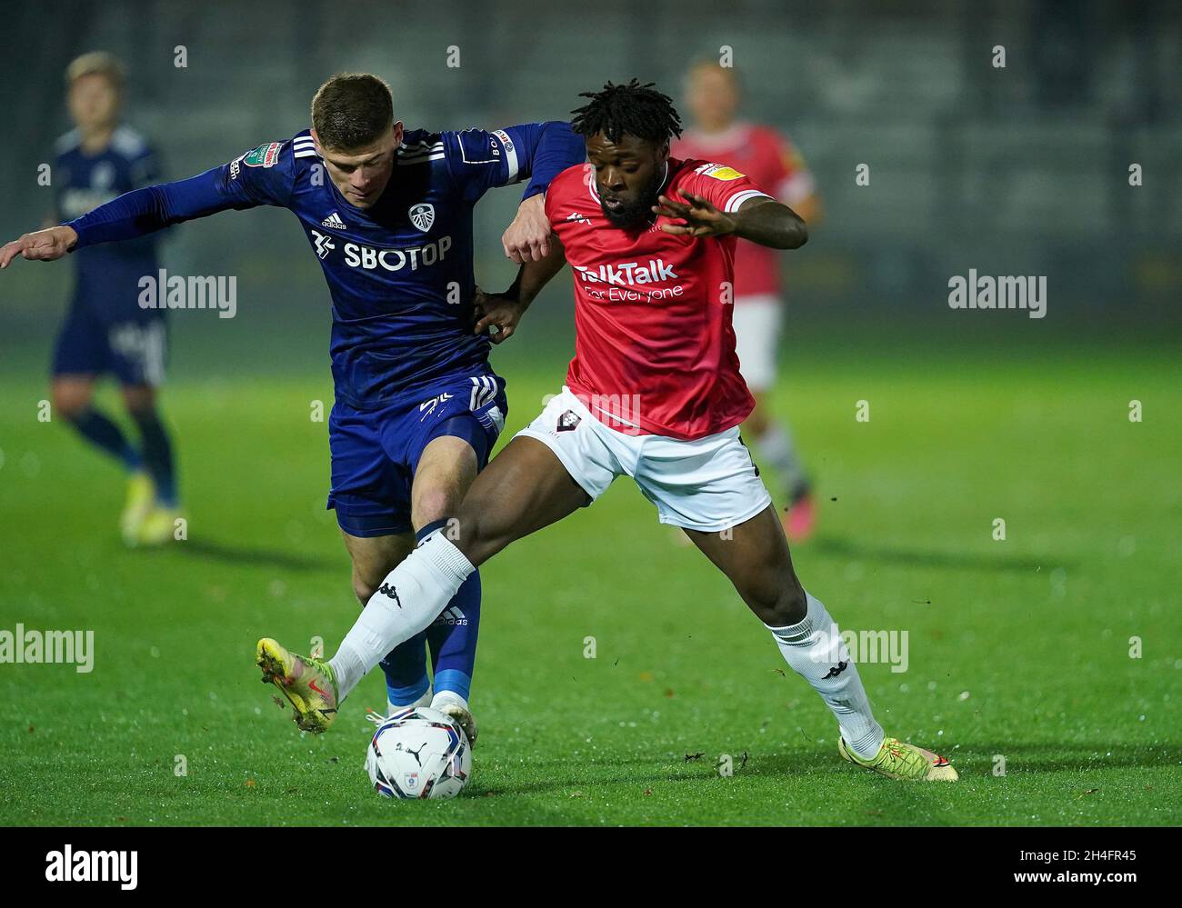 Salford City's Aramide Oteh battles for the ball with Leeds United U21's Charlie Creswell during the Papa John's Trophy Northern Group B match at Moor Lane, Salford. Picture date: Tuesday November 2, 2021. Stock Photo