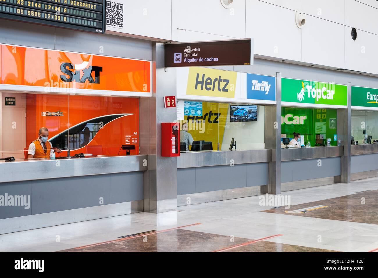 Tenerife, Spain - September, 2021: Car rental counters from various rent a car companies in airpot Stock Photo