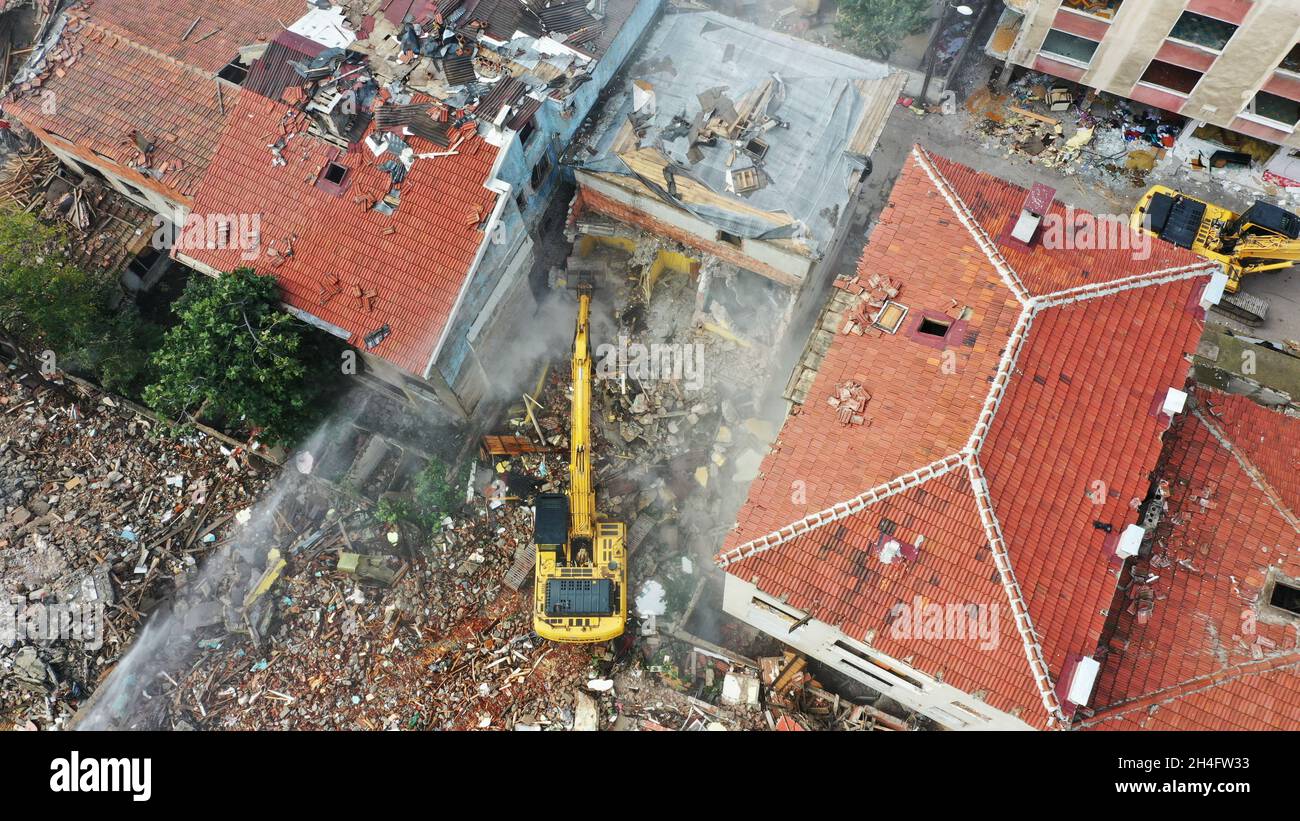 Aerial drone view on excavators demolishing a building. Aerial drone view about urban transformation. Aerial view of building demolition in the city c Stock Photo