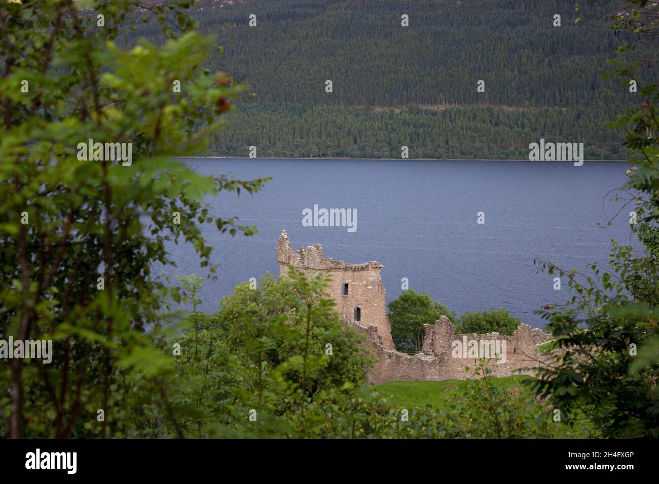 Scotland, Highlands, Urquhart Castle, Drumnadrochit, Loch Ness, Greenery, Light Beam on Mountainside, Mountain Top, Scottish Scenery, Blue Waters Stock Photo