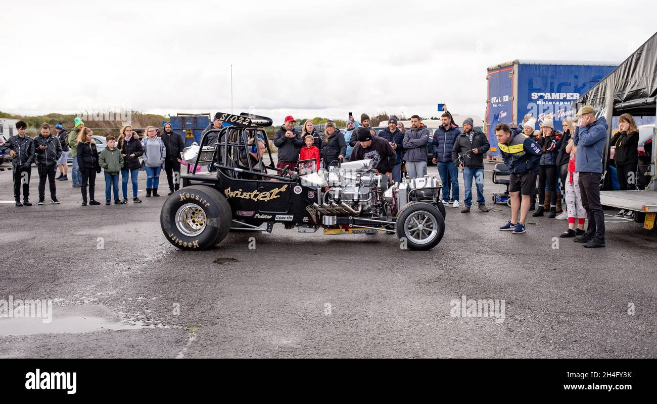 Race goers and spectators gathered around the Twister drag racing car in  the pits whilst it is being tuned and prepped to run the quarter mile at  the Stock Photo - Alamy
