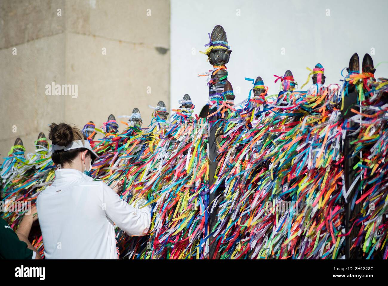 Salvador, Bahia, Brazil - January 01, 2021: People wearing face mask and praying at Senhor do Bonfim church in Salvador, Bahia, Brazil. Stock Photo