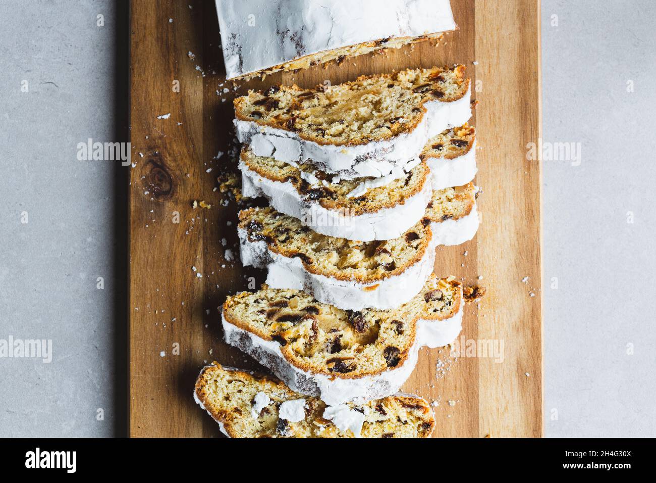 Directly above shot of Marzipan Stollen cake with icing sugar, sliced Stock Photo
